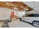 Spacious garage features steps to the back door, overhead lighting and a white SUV at 20 Scott Dr, Broomfield, CO 80020