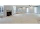 Open living room boasts neutral carpet, fireplace, modern fan, and natural light at 20 Scott Dr, Broomfield, CO 80020