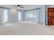 Neutral living room with modern ceiling fan, large windows, and good lighting at 20 Scott Dr, Broomfield, CO 80020