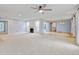 Open living room boasts neutral carpet, fireplace, modern fan, and natural light at 20 Scott Dr, Broomfield, CO 80020
