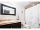 Bathroom featuring a vanity with marble countertops, a framed mirror, and shower with floral pattern at 452 N Finch Ave # 452B, Lafayette, CO 80026