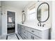 Bright bathroom with dual sinks, dark fixtures and decorative mirrors at 452 N Finch Ave # 452B, Lafayette, CO 80026