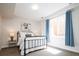 Cozy bedroom with a black metal bed frame, bright window, and stylish blue curtains at 452 N Finch Ave # 452B, Lafayette, CO 80026