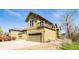 Two-story townhome featuring a garage, light yellow siding, and a balcony on the second level at 452 N Finch Ave # 452B, Lafayette, CO 80026