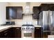 Modern kitchen with stainless steel appliances, dark wood cabinets, and tile backsplash at 452 N Finch Ave # 452B, Lafayette, CO 80026