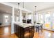 Open kitchen featuring dark cabinets, island, and seamlessly attached dining area at 452 N Finch Ave # 452B, Lafayette, CO 80026
