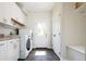 Laundry room with white cabinetry, washer and dryer, and exterior door at 452 N Finch Ave # 452B, Lafayette, CO 80026