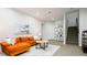 Bright living room with orange sofa, artwork, and built-in shelving, enhancing the home's inviting ambiance at 452 N Finch Ave # 452B, Lafayette, CO 80026