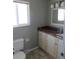 Bathroom features a marble countertop, vanity, toilet, and window at 1510 S Macon St, Aurora, CO 80012