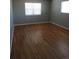 A bedroom with hardwood flooring and neutral-colored walls and trim at 1510 S Macon St, Aurora, CO 80012