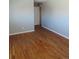 Bedroom with hardwood floors, light grey walls and white door at 1510 S Macon St, Aurora, CO 80012