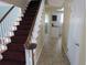 Hallway with tile flooring leading to staircase and showing the kitchen at 1510 S Macon St, Aurora, CO 80012