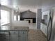 Open-concept kitchen featuring granite counters, white cabinets, and views into a cozy living area with a fireplace at 1510 S Macon St, Aurora, CO 80012