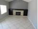 Comfortable living area with a stone fireplace flanked by built-in shelves and neutral-colored tile flooring at 1510 S Macon St, Aurora, CO 80012