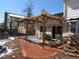 Stamped concrete patio with a wooden pergola and string lights at 1510 S Macon St, Aurora, CO 80012