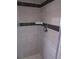 Shower featuring tile walls, black accent stripe, and soap holder at 1510 S Macon St, Aurora, CO 80012