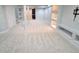 Finished basement area with carpet and shelving unit, ideal for entertaining at 8772 S Carr Way, Littleton, CO 80128