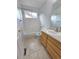 Cozy bathroom with shower and tub, white tile, and wood vanity at 8772 S Carr Way, Littleton, CO 80128