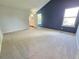 Spacious bedroom with an ensuite bathroom, large windows and blue accent wall at 8772 S Carr Way, Littleton, CO 80128