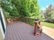Wooden deck with brown railings overlooking the lush backyard at 8772 S Carr Way, Littleton, CO 80128