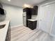 Kitchenette with sleek black cabinets, light countertops and stainless steel refrigerator at 8772 S Carr Way, Littleton, CO 80128