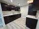 Kitchenette with sleek black cabinets, light countertops and modern appliances at 8772 S Carr Way, Littleton, CO 80128