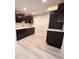 Kitchenette with sleek black cabinets, light countertops and modern appliances at 8772 S Carr Way, Littleton, CO 80128