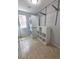 Well-organized laundry room with stacked washer/dryer, shelving, and tile flooring at 8772 S Carr Way, Littleton, CO 80128