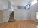 Open-concept living room with hardwood floors and staircase leading to the second floor at 8772 S Carr Way, Littleton, CO 80128
