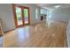 Open living room with hardwood floors, fireplace, and sliding glass doors to the backyard deck at 8772 S Carr Way, Littleton, CO 80128