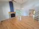 Bright living room with hardwood floors, stone fireplace, and vaulted ceilings at 8772 S Carr Way, Littleton, CO 80128