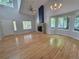 Spacious living room featuring hardwood floors, stone fireplace, and large bay window at 8772 S Carr Way, Littleton, CO 80128