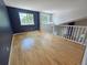 Upstairs living room featuring hardwood floors and two large windows overlooking the neighborhood at 8772 S Carr Way, Littleton, CO 80128