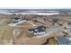 Stunning aerial view of a modern home with a private driveway near a picturesque, partially frozen lake at 10291 E 142Nd Ave, Brighton, CO 80602