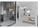 Luxurious bathroom boasts dual sinks, a large glass-enclosed shower, and access to a walk-in closet for ample storage at 10291 E 142Nd Ave, Brighton, CO 80602