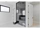 Elegant bathroom showcases a freestanding tub, sleek black-framed windows, and a modern glass shower enclosure at 10291 E 142Nd Ave, Brighton, CO 80602