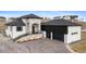 Stunning two-story home showcasing stone accents, a black roof, and an attached two-car garage at 10291 E 142Nd Ave, Brighton, CO 80602