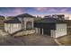 Stunning two-story home showcasing stone accents, a black roof, and an attached two-car garage at 10291 E 142Nd Ave, Brighton, CO 80602