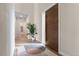 Bright foyer showcasing a modern front door, light wood floors and an eye-catching area rug at 10291 E 142Nd Ave, Brighton, CO 80602