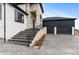 Stairs lead to the stunning front entrance, accentuated by stone and modern black railings at 10291 E 142Nd Ave, Brighton, CO 80602