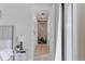 Bright hallway features modern lighting, wood flooring, and a view into another room with vertical wood accents at 10291 E 142Nd Ave, Brighton, CO 80602