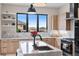 Close up of the kitchen featuring modern appliances, a kitchen island, and marble countertops and backsplash at 10291 E 142Nd Ave, Brighton, CO 80602