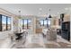 Open-concept kitchen and dining area with large windows, modern appliances, and a stylish kitchen island at 10291 E 142Nd Ave, Brighton, CO 80602