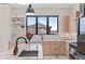 Close-up of kitchen featuring modern appliances, a kitchen island with a sink and stylish cabinetry at 10291 E 142Nd Ave, Brighton, CO 80602