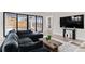 Bright living room featuring a modern sofa, and a large window that offers amazing views of the property at 10291 E 142Nd Ave, Brighton, CO 80602