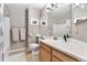Neutral bathroom showcasing a vanity with solid surface, a large mirror, and a shower/tub combo at 9503 Longs Peak Dr, Commerce City, CO 80640