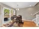 Comfortable dining area has hardwood floors, modern lighting and glass doors that open to an outdoor patio at 9503 Longs Peak Dr, Commerce City, CO 80640