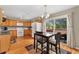 Cozy dining area features hardwood floors, wood cabinetry, and a sliding glass door to the deck at 9503 Longs Peak Dr, Commerce City, CO 80640