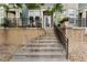 The home's exterior features a stone foundation, leading to a welcoming front entry with black metal railings and flowering plants at 9503 Longs Peak Dr, Commerce City, CO 80640