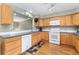 Spacious kitchen features wood cabinets, updated appliances, hardwood floors and ample counter space at 9503 Longs Peak Dr, Commerce City, CO 80640